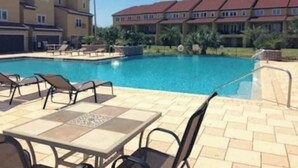 A swimming pool with lounge chairs and a tiled deck. - Pensacola Beach - 4 Bedrooms w/ Beach and Pool Access! (Pensacola Beach)