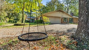 A house with a swing set in the yard. - Timber View Retreat-Large 4 BR close to shopping & restaurants in NE Longview (Longview)