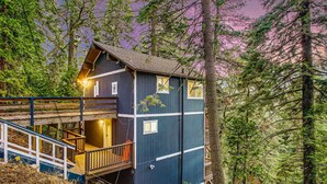 A cabin with a wooden deck and stairs leading to a balcony, surrounded by dense forest. - Tree-Lined Lake Arrowhead Cabin ~ 1 Mi to Village! (Lake Arrowhead)