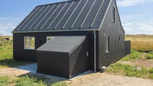 A modern, dark-colored house with a sloped roof and solar panels. - "Helga" - 800m from the sea by Interhome (Skagen)