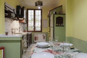 A kitchen with a dining area set for a meal.