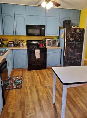 Enjoy cooking in this well-equipped kitchen with a stove, microwave, toaster, and refrigerator.