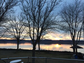 A lakeside view with trees and a gazebo. - Sunset Waters: Serene Retreat on the Mississippi River Shoreline Fisher Friendly (Stoddard)