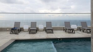 A rooftop pool area with lounge chairs and a view of the sea. - Cartagena Home with a Heavenly View (Cartagena)