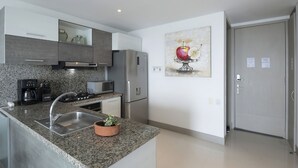 A modern kitchen with granite countertops, stainless steel appliances, and a potted plant. - Cartagena Home with a Heavenly View (Cartagena)
