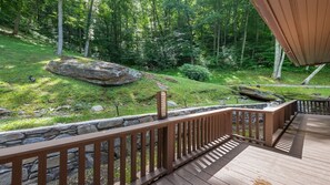 Enjoy a serene view of the surrounding forest from this elevated deck.