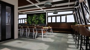 A modern restaurant interior with a high ceiling, wooden beams, and large windows.