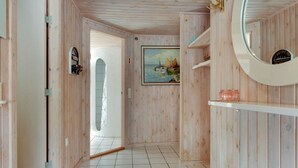 A room with wooden walls, a tiled floor, a painting, a mirror, and a shelf. - "Minka" - 300m from the sea by Interhome (Nexø)