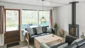 A cozy living room with a sofa, coffee table, and a fireplace. - "Michel" - 300m from the sea by Interhome (Nexø)