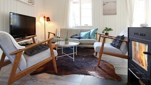 A cozy living room with a television, a fireplace, and a sofa. - "Ronja" - 300m from the sea by Interhome (Nexø)