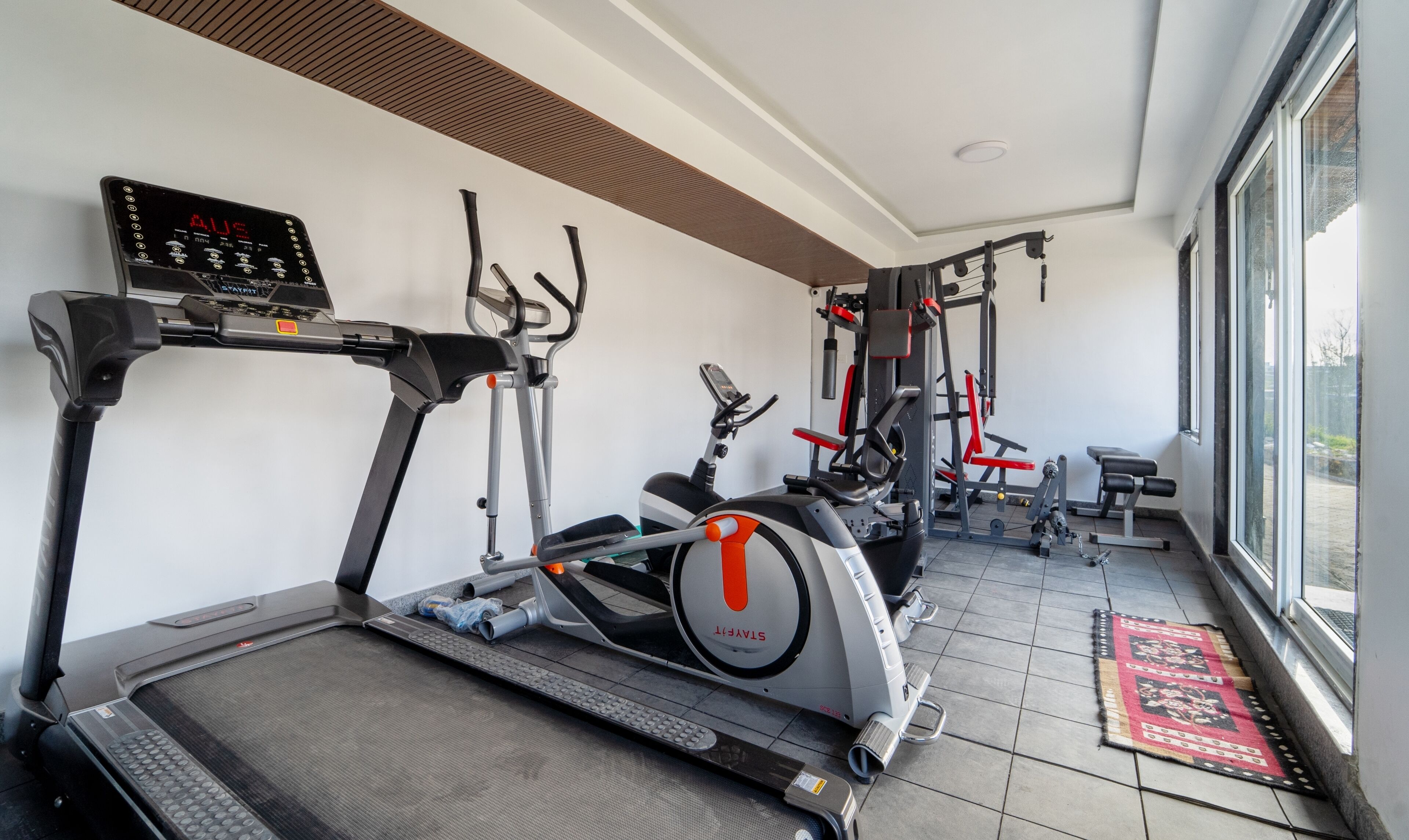 A gym with treadmills, a stationary bike, and weight machines.