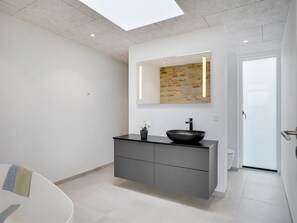 A modern bathroom with a black vessel sink, grey cabinetry, a large mirror, and a skylight. - "Ahmik" - 200m from the sea by Interhome (Ebeltoft)