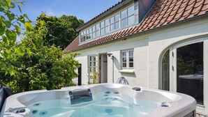 A hot tub in a backyard with a house in the background. - "Malinda" - 500m from the sea by Interhome (Odder)