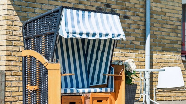 A beachside kiosk with a striped awning, wooden structure, and a small seating area. - "Ingward" - 750m from the sea by Interhome (Vestervig)