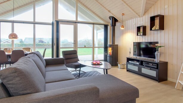 A modern living room with a sectional sofa, a TV, and a fireplace. - "Gertrude" - 1.1km to the fjord by Interhome (Hemmet)
