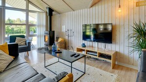 A modern living room with a large TV, a fireplace, and a cozy seating area. - "Eicke" - 12km from the sea by Interhome (Oksbøl)
