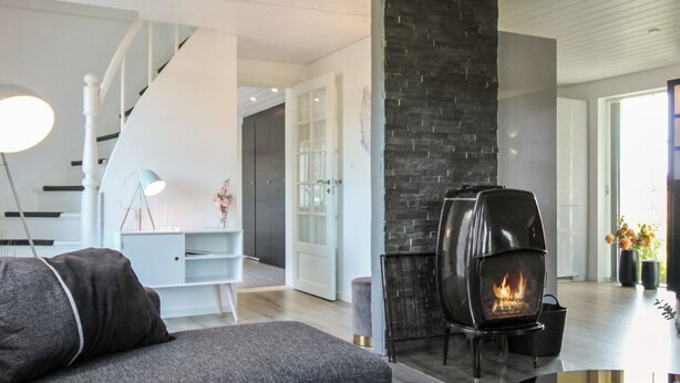 A modern living room with a fireplace, a staircase, and a minimalist design. - "Rask" - 3km from the sea by Interhome (Allinge)