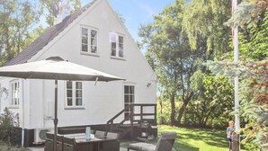 A house with a patio area featuring outdoor furniture and a grill. - "Rask" - 3km from the sea by Interhome (Allinge)