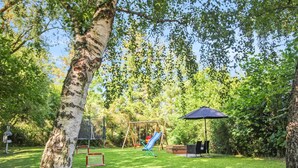 A backyard with a swing set, a slide, a bench, and a covered seating area. - "Rask" - 3km from the sea by Interhome (Allinge)