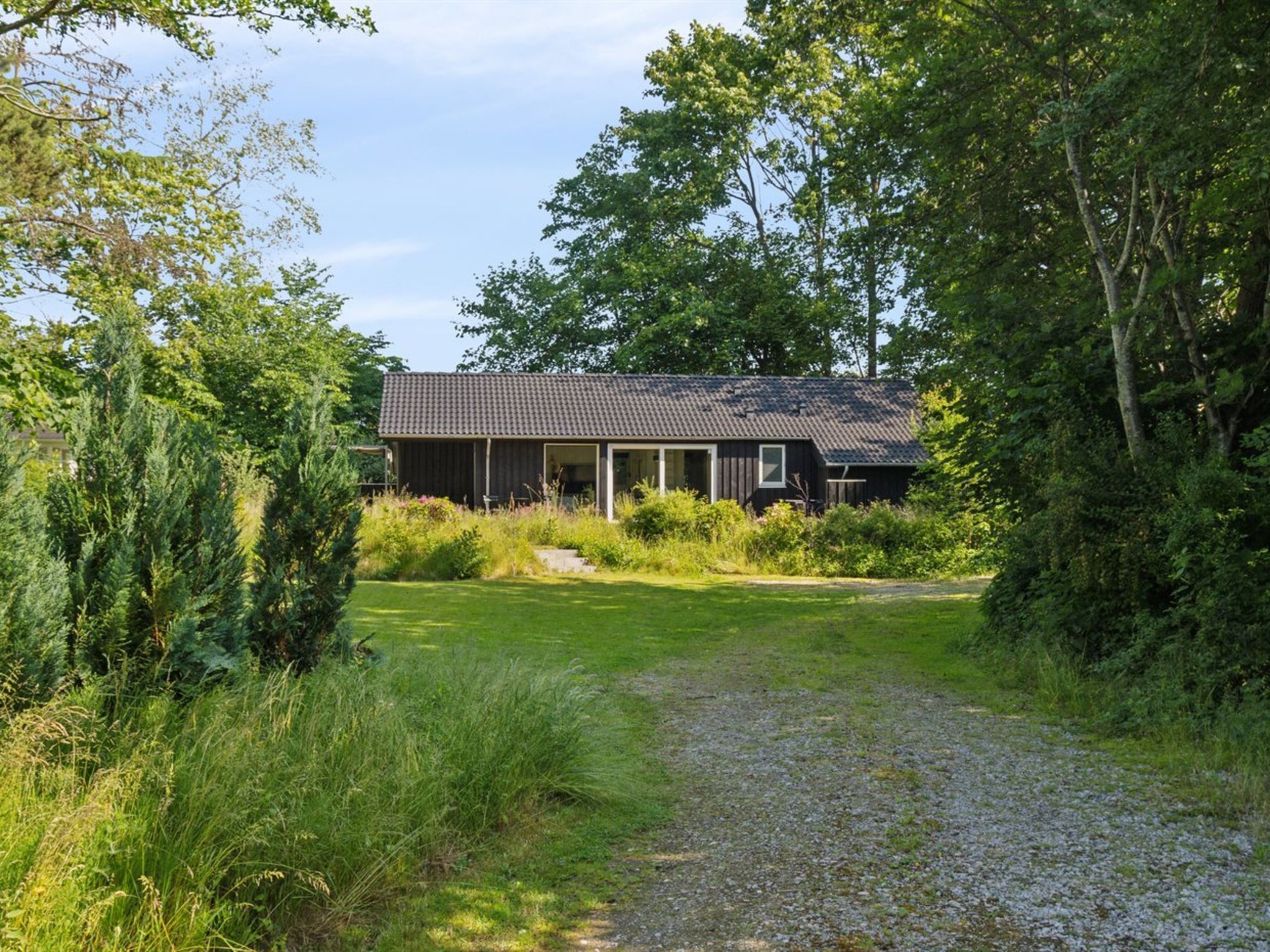 A single-story house with a dark roof and a covered porch.
