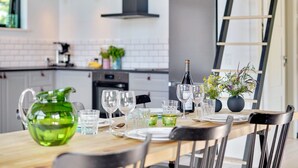 A modern kitchen with a dining area set for a meal.