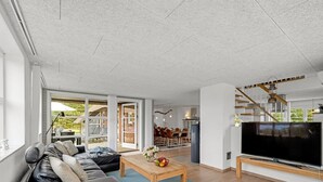 A modern living room with a sofa, coffee table, and TV. - "Vangel" - 500m from the sea by Interhome (Blåvand)