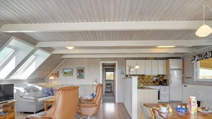 A modern interior with a dining area, kitchen, and seating with a view of the outdoors. - "Alleta" - 600m from the sea by Interhome (Ringkøbing)
