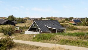 A modern house with a sloped roof and solar panels, surrounded by a rural landscape. - "Alleta" - 600m from the sea by Interhome (Ringkøbing)