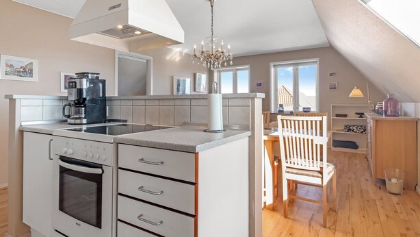 A modern kitchen with a Bosch oven, a coffee maker, and a chandelier. - "Gerrit" - 450m from the sea by Interhome (Løkken)