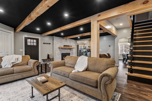 Large open living room with a gas fireplace, Smart TV, books and games!