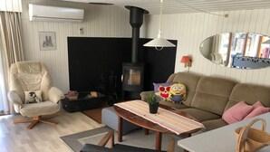 A cozy living room with a sofa, armchair, and a small table with a plant. - "Harald" - 300m from the sea by Interhome (Idestrup)