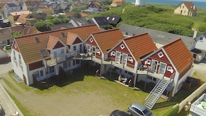 A residential area with a cluster of houses featuring red-tiled roofs and a prominent white water tower in the background. - "Haghni" - 200m from the sea by Interhome (Løkken)