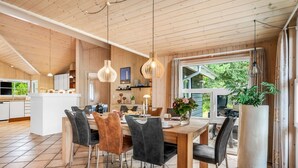 A modern kitchen with a central island, wooden ceiling, and large windows. - "Tule" - 1.2km from the sea by Interhome (Blåvand)