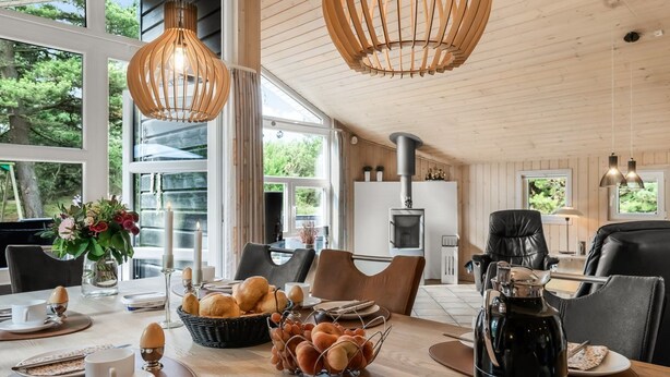 A dining area with a wooden table set for breakfast, including eggs, bread, and a coffee pot. - "Tule" - 1.2km from the sea by Interhome (Blåvand)