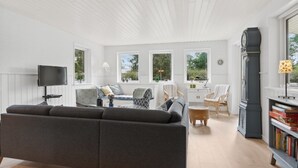A modern living room with a grey sofa, a flat-screen TV, and a bookshelf. - "Asla" - 400m from the sea by Interhome (Hals)