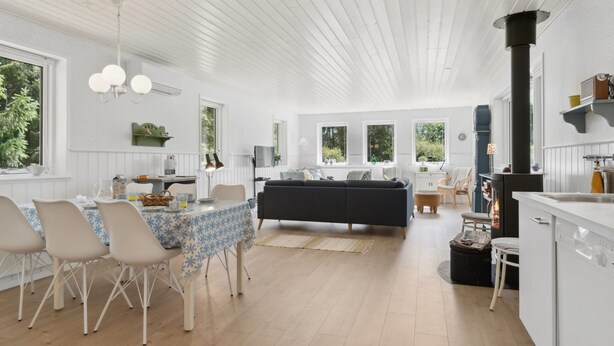 A spacious living area with a dining table, chairs, a sofa, and a kitchen area with a stove. - "Asla" - 400m from the sea by Interhome (Hals)