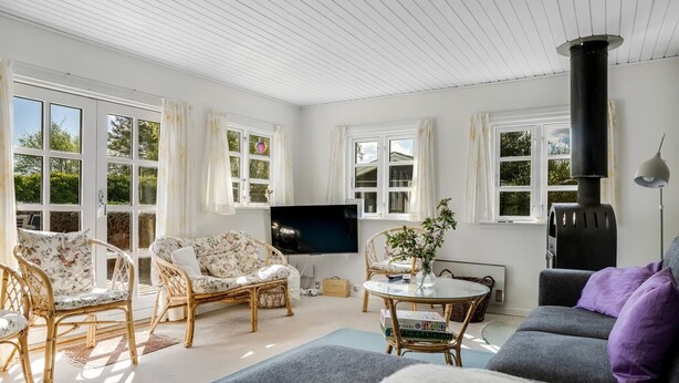 A cozy living room with wicker furniture, a television, and a fireplace. - "Ingobert" - 50m from the sea by Interhome (Hals)