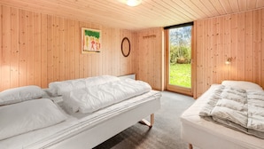 A room with wooden walls and a large window. There are two beds with white bedding. - "Scarlet" - 400m to the fjord by Interhome (Vinderup)