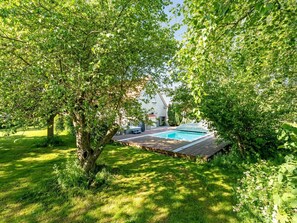 A swimming pool surrounded by lush greenery and trees. - "Thorward" - 1.5km from the sea by Interhome (Idestrup)