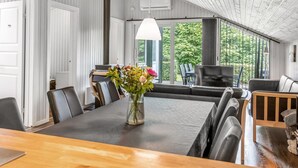 A modern dining area with a large table, chairs, and a vase of flowers. - "Corinna" - 28km from the sea by Interhome (Toftlund)