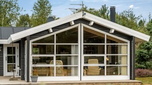A modern house with a large glass front and a sloped roof. - "Jannus" - 550m from the sea by Interhome (Hals)