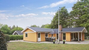 A two-story house with a covered patio area, a chimney, and a small garden. - "Friedeman" - 29km from the sea by Interhome (Toftlund)