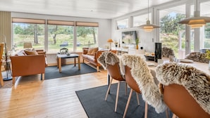 A spacious living area with a large window, a television, and a dining table with chairs. - "Gloria" - 2.5km from the sea by Interhome (Blokhus)