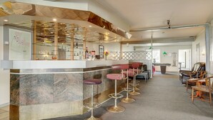 A modern bar area with a marble counter, multiple stools, and a pool table in a spacious room with a high ceiling and a view of the outdoors. - "Stilla" - 35km from the sea by Interhome (Højer)