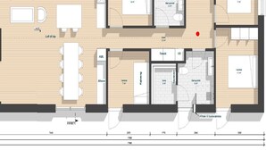 Un plan d’étage d’un hôtel comprenant une cuisine, un coin repas, deux chambres, une salle de bain et un salon.