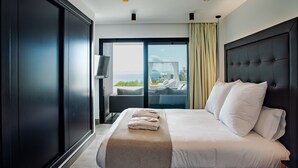 Ein modernes Hotelzimmer mit einem großen Bett, einem Fernseher und einem Balkon mit Blick.