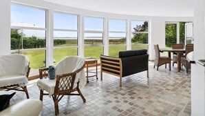 A spacious room with large windows offering a view of a grassy area and the sea. - "Vemund" - 100m to the fjord by Interhome (Vig)