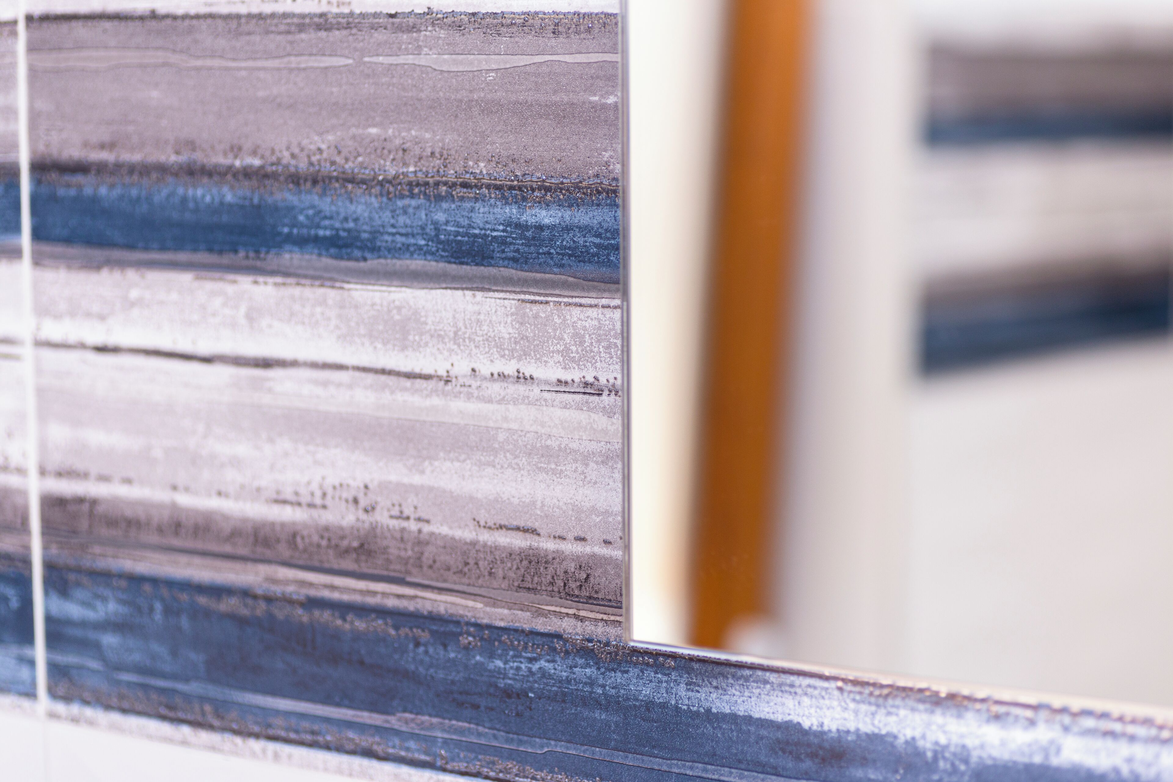 A close-up of a textured wall with horizontal lines and a partial view of a door frame.
