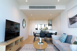 Deluxe Apartment | Living area | 55-inch LED TV with cable channels