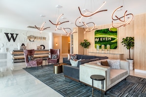 Relax in style at our lobby, featuring a minimalist reception desk, comfortable seating areas, and a unique light fixture.